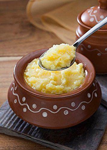 Traditional ghee preparation in a brass pot
